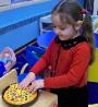Making a pretend-pizza at school