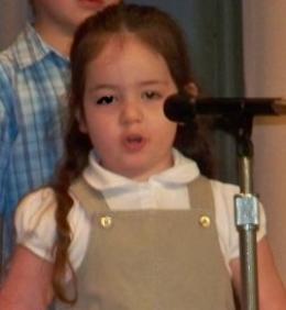 Performing on stage at my preschool graduation.
