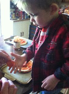 Brayden is making his own pizza.