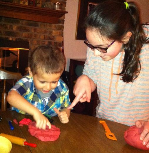Helping Johnny with play dough.