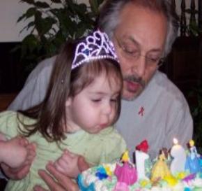 Helping Daddy blow out his birthday candles.